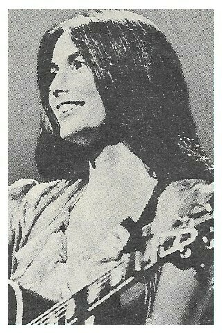 Harris, Emmylou / On Stage, Smiling, Profile, with Guitar / 1970s