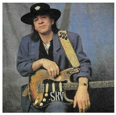 Vaughan, Stevie Ray / Dark Purple Outfit-Blue Background / 1990