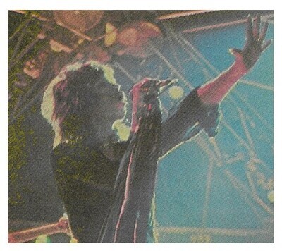 Aerosmith / Steven Tyler On Stage-Holding Mic Stand-Looking Upward / 1977