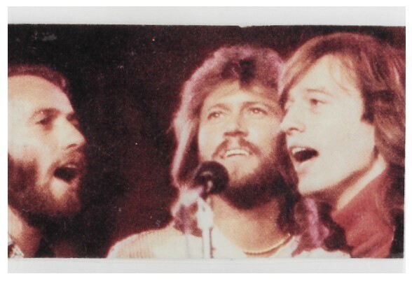 Bee Gees / On Stage-Barry in Center-Dark Background / 1979