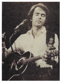 Diamond, Neil / On Stage, Eyes Closed, Strumming Guitar / 1976