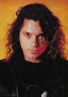 INXS / Michael Hutchence, Orange Background, Black Jacket / 1987