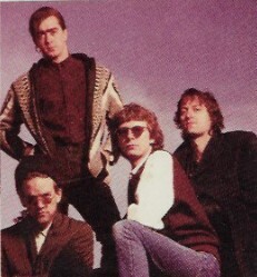 R.E.M. / Group Photo, Outdoors, Michael at Lower Left / 1989