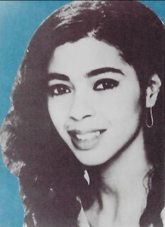 Cara, Irene / Closeup, Smiling, Blue Background / 1980