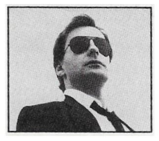 Southside Johnny / Standing-Wearing Sunglasses, Suit and Tie / 1986