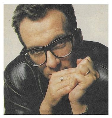 Costello, Elvis / Closeup--Black Jacket--Hands Together / 1989