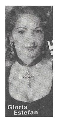 Estefan, Gloria / Closeup-Wearing Cross Necklace