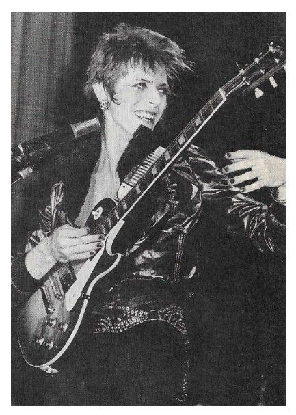 Bowie, David / On Stage, Smiling, with Electric Guitar / 1970s