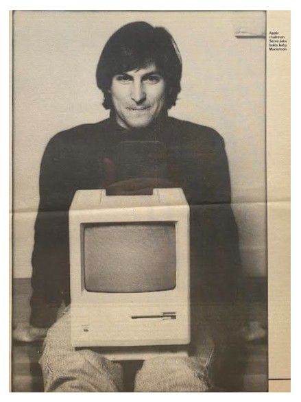 Jobs, Steve / Holds Baby Macintosh / 1984