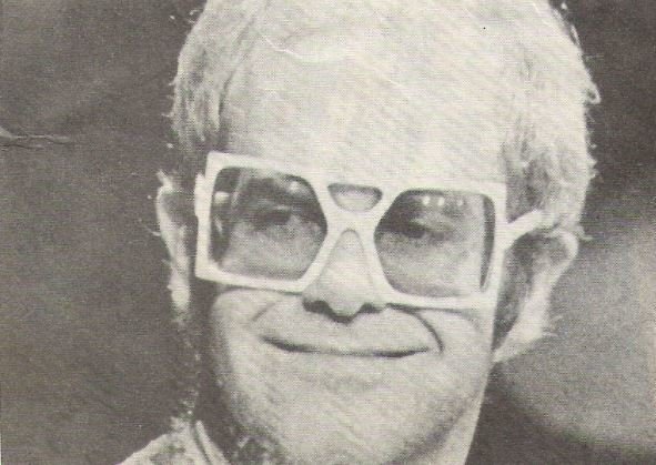 John, Elton / Closeup, Square Glasses, Smiling / 1976