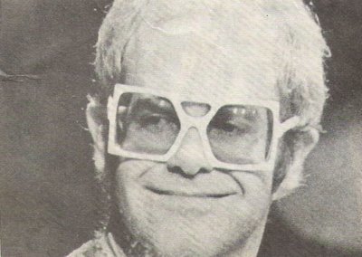 John, Elton / Closeup, Square Glasses, Smiling / 1976