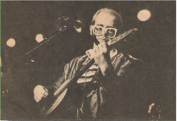 John, Elton / Playing Guitar On Stage, Striped Shirt / 1976