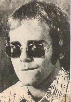 John, Elton / Closeup, Patterned Shirt, Wire-Rim Glasses / 1971