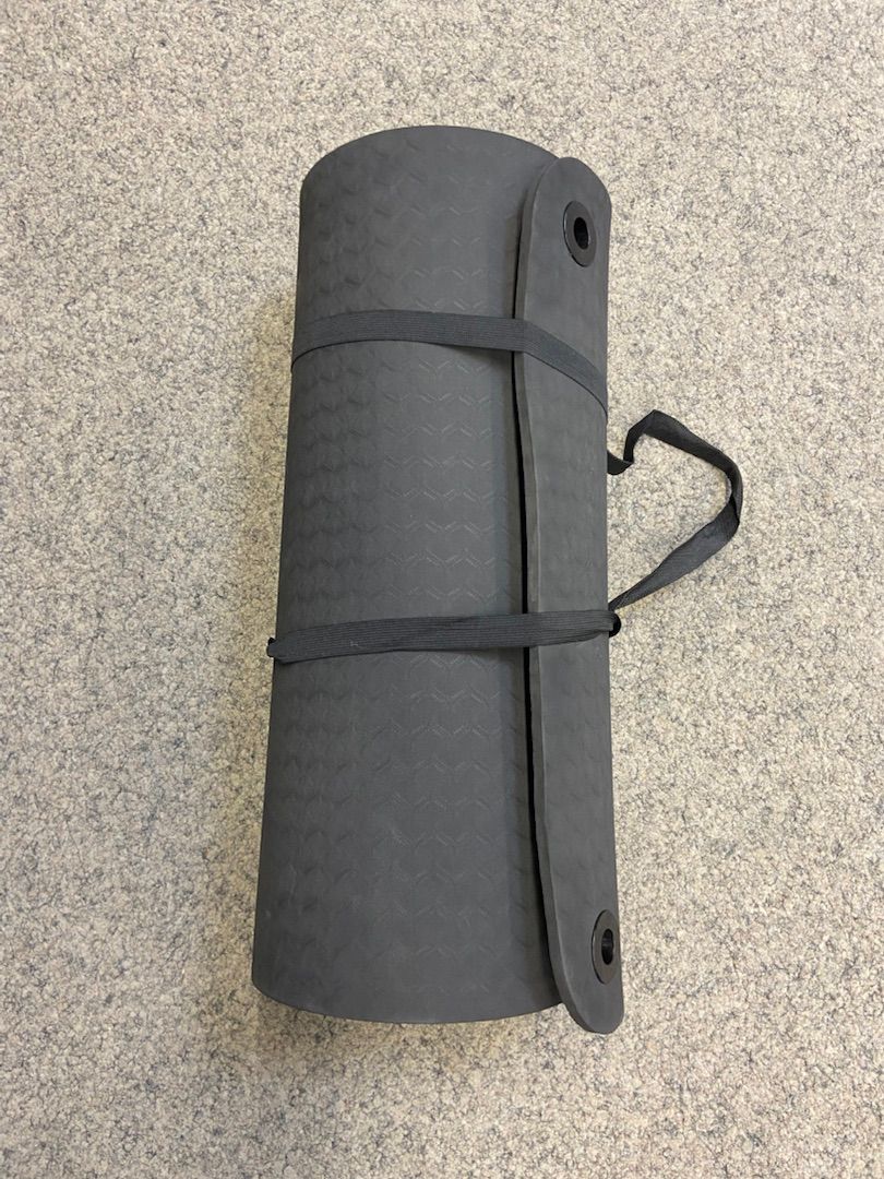 Dark grey yoga mat with practical carrying strap