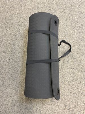 Dark grey yoga mat with practical carrying strap