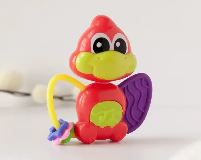 Mordedor Musical Dinossauro Kiokids vermelho com luzes e sons para bebês a partir de 3 meses.