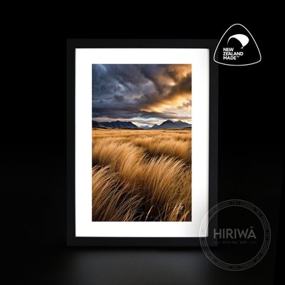 Windswept Plains landscape artwork with golden grasses, distant mountains and dramatic storm clouds by Hiriwā Digital Art.