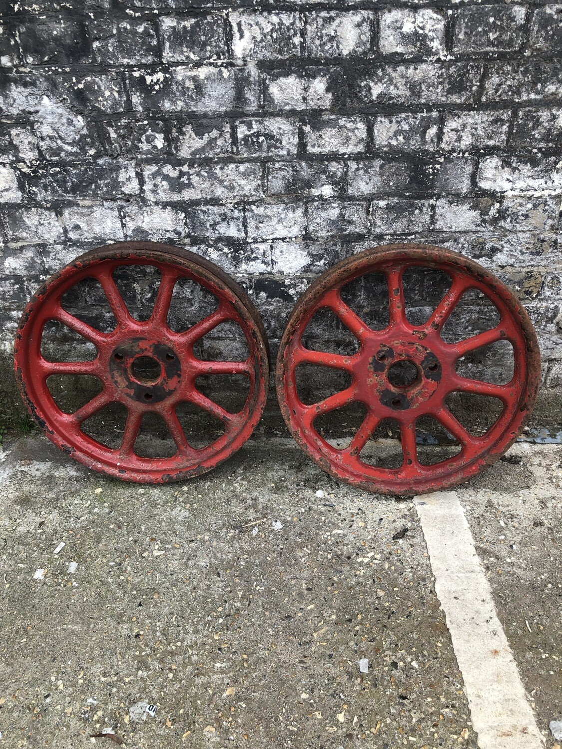 a pair of antique artillery wheels