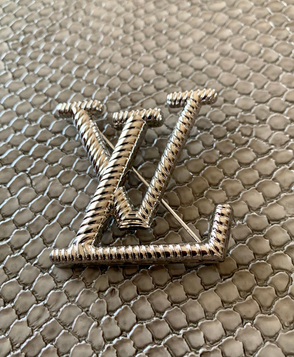 Lv brooch
