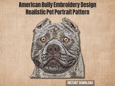 Embroidery of American Bully dog head in gray and brown thread with golden eyes and strong facial features on a light fabric.