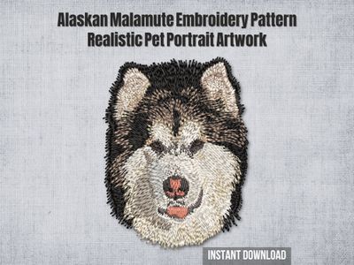 Embroidery of an Alaskan Malamute dog head in cream, brown, and black thread with pink nose and fluffy fur on a light fabric.