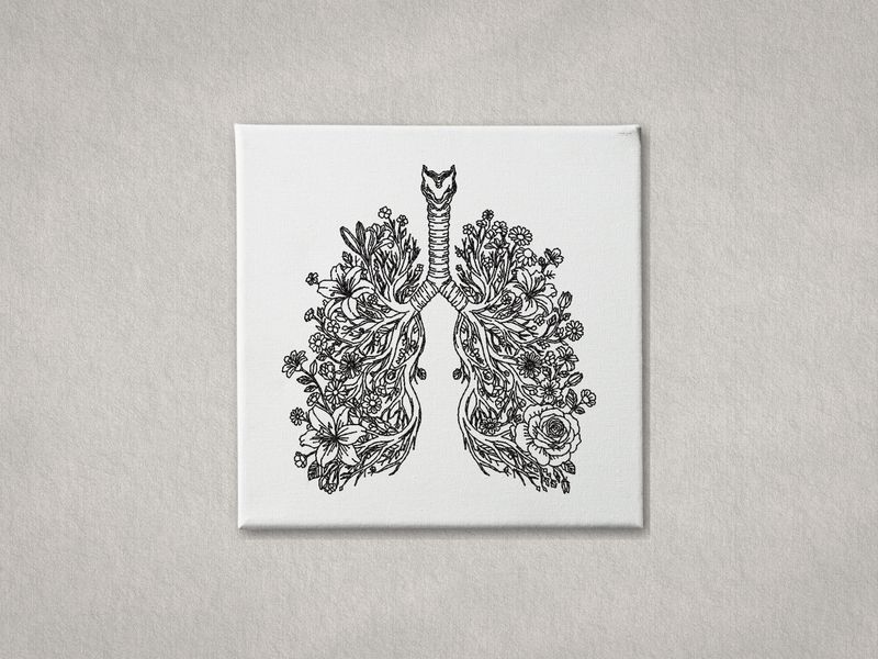 Detailed black embroidered anatomical lungs with flowers on white gallery-wrapped canvas. Minimalist grey wall background.