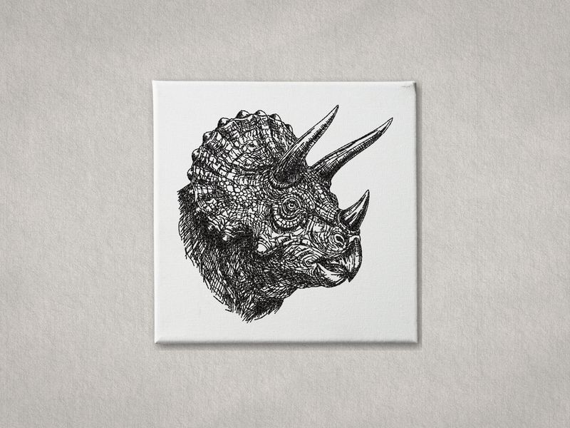 Detailed black embroidered Triceratops head on white gallery-wrapped canvas. Minimalist grey textured wall background.