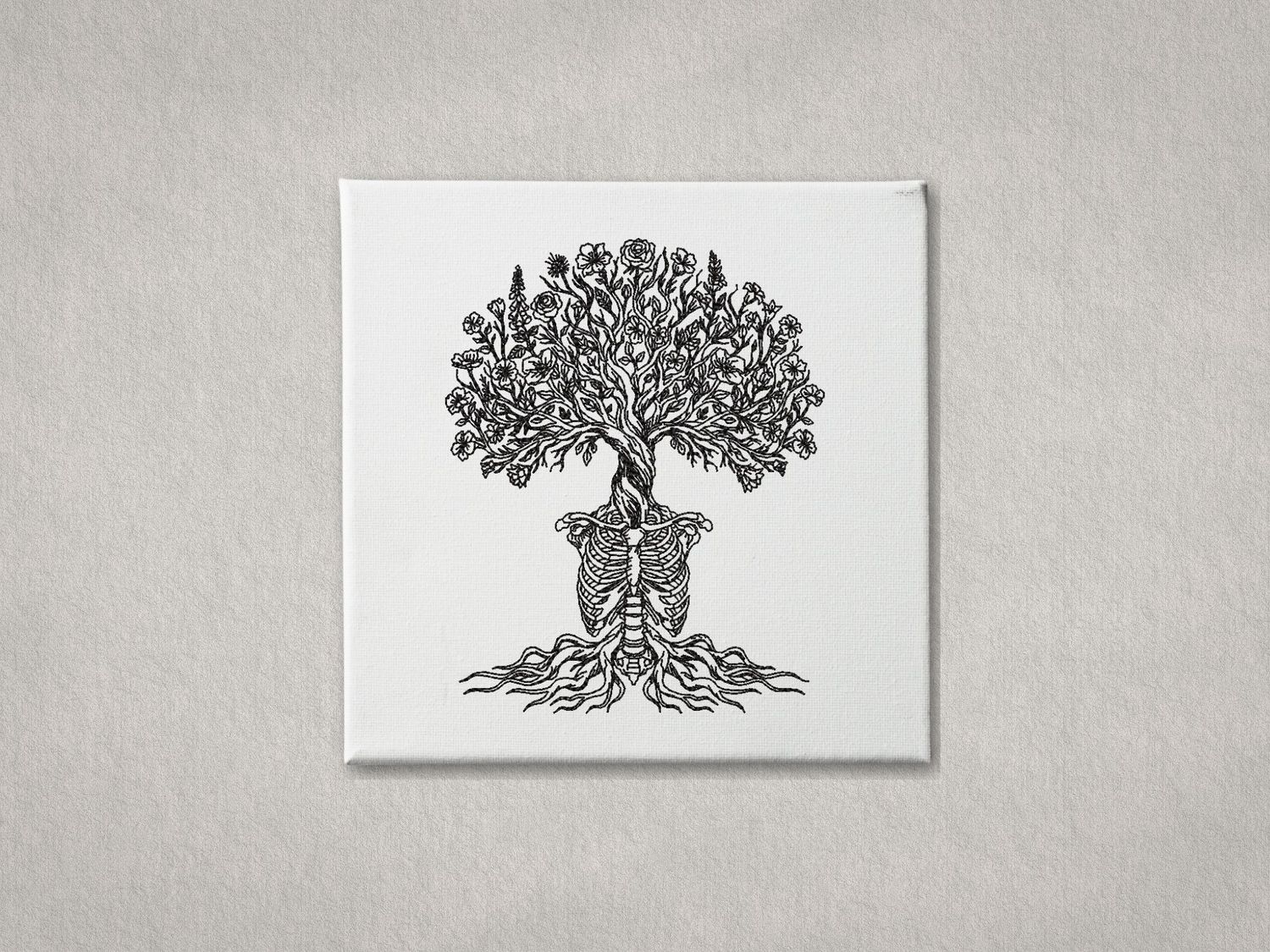 Intricate embroidered skeleton tree of life on a white gallery-wrapped canvas. Centered against a textured grey background.