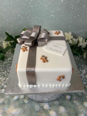 Christmas Parcel With Silver Bow And Gingerbread Men
