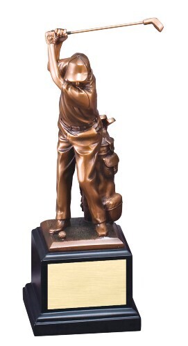 Golfer swinging next to bag