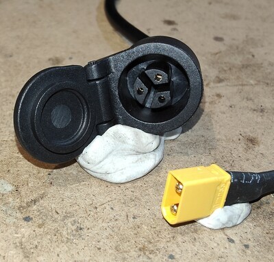 Kaabo Mantis King GT /  Wolf Warrior GT (newer) / GTR LP16 style 3-pin charging port (panel socket) with hinged cover.