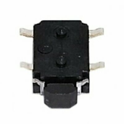 Black SMD switch shaped like a flat tortoise with four metal legs and switch head with metal shoulder blades