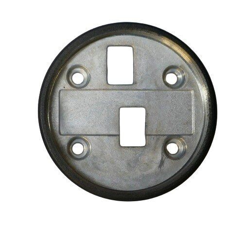 Circular coated metal plate with black outer surface and with four round holes and two rectangular holes in central section