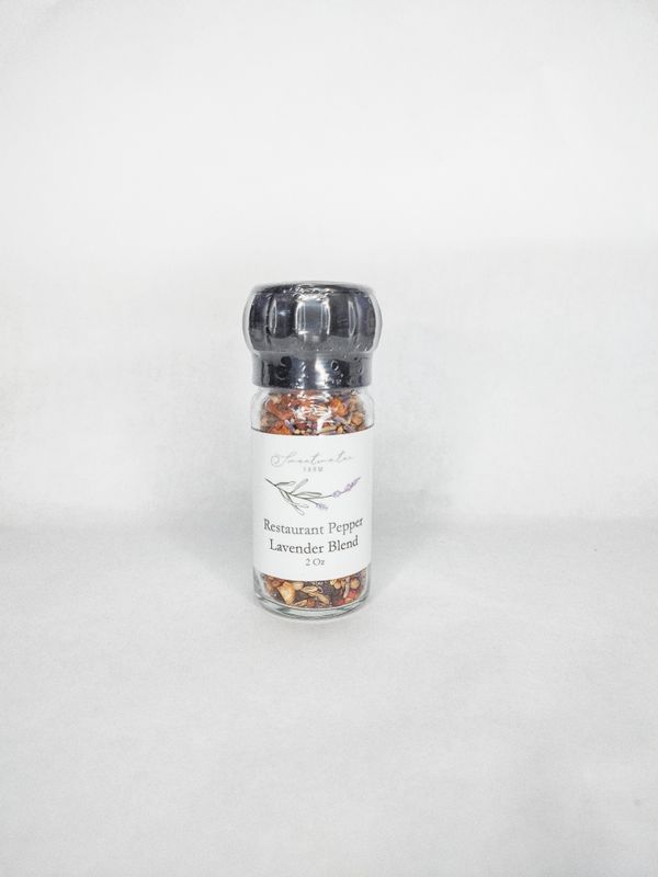 Culinary lavender and black pepper seasoning in glass grinder jar
