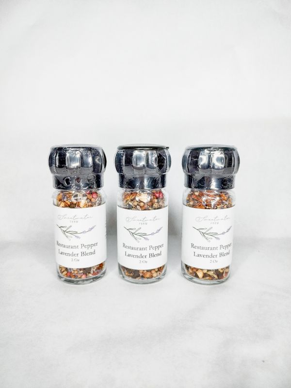 Three culinary lavender and black pepper seasoning in glass grinder jars