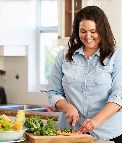 Preparing fresh salad on cutting board with culinary lavender vinegar for flavor