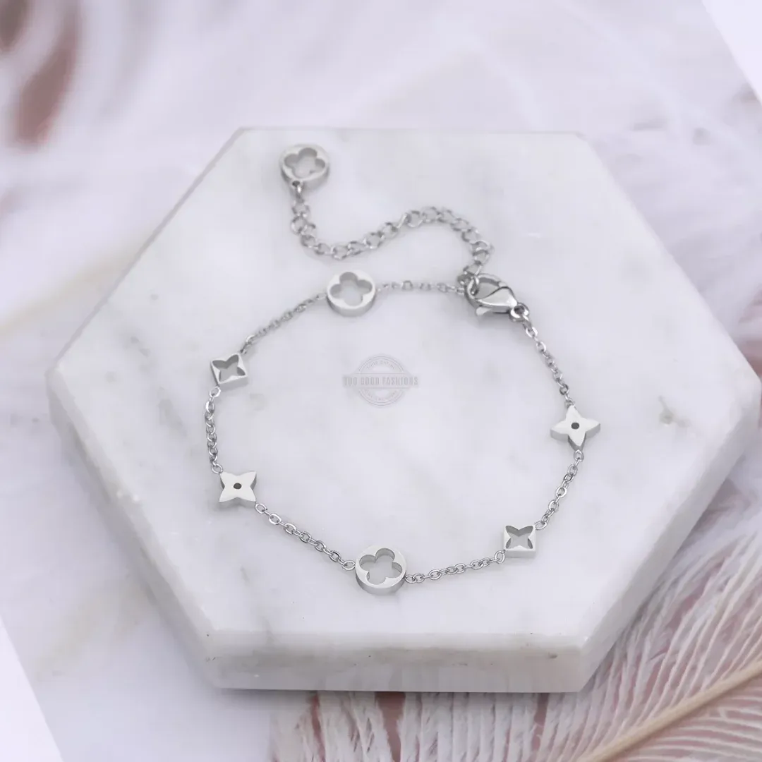 Silver bracelet with four-leaf clover and star design, elegant accessory