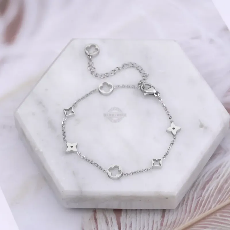Silver bracelet with four-leaf clover and star design, elegant accessory