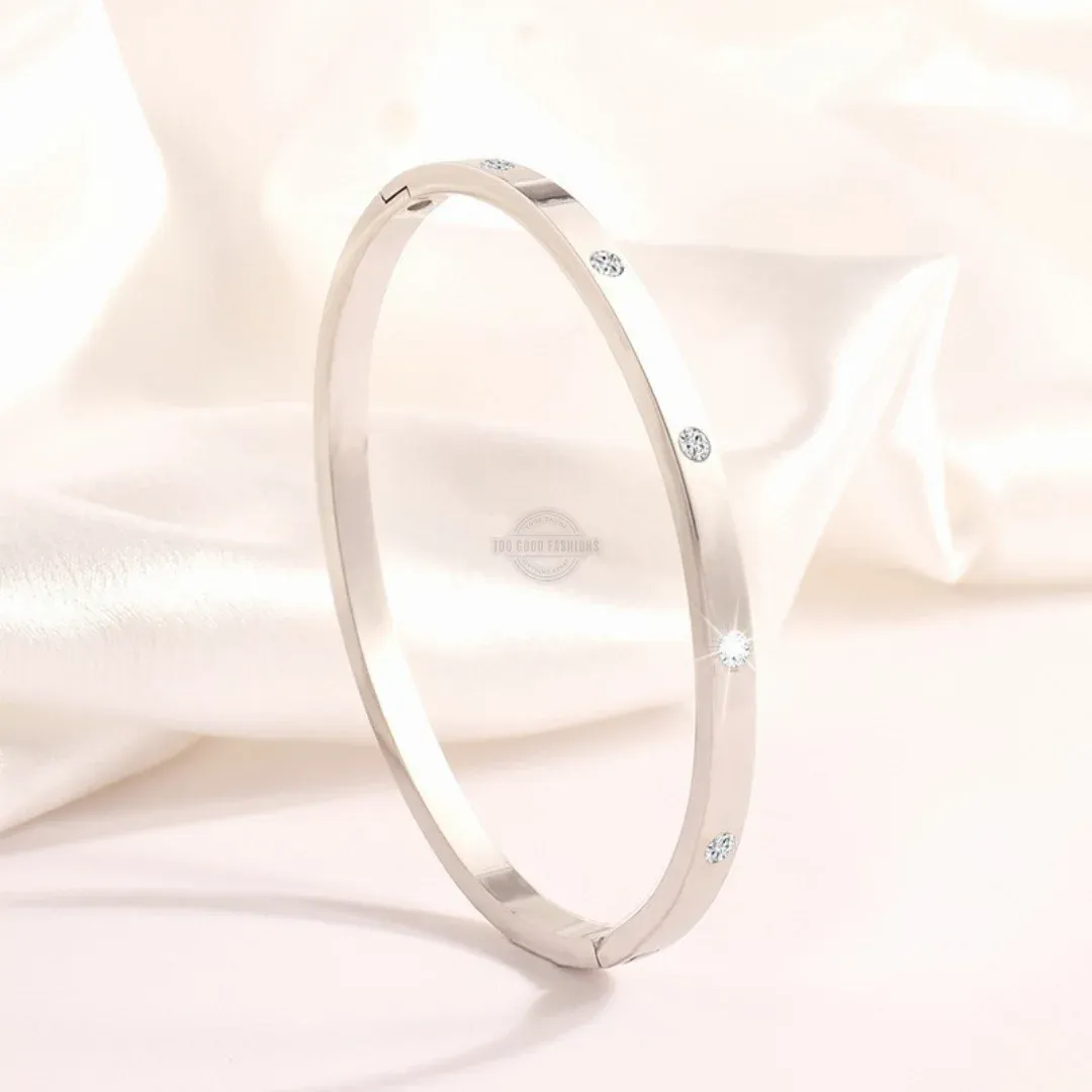 Silver stainless steel bangle with delicate inlaid gems