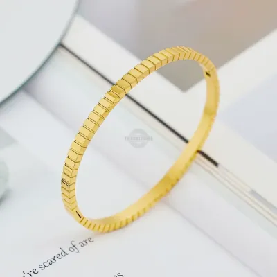 Gold stainless steel bangle with stacked cube design