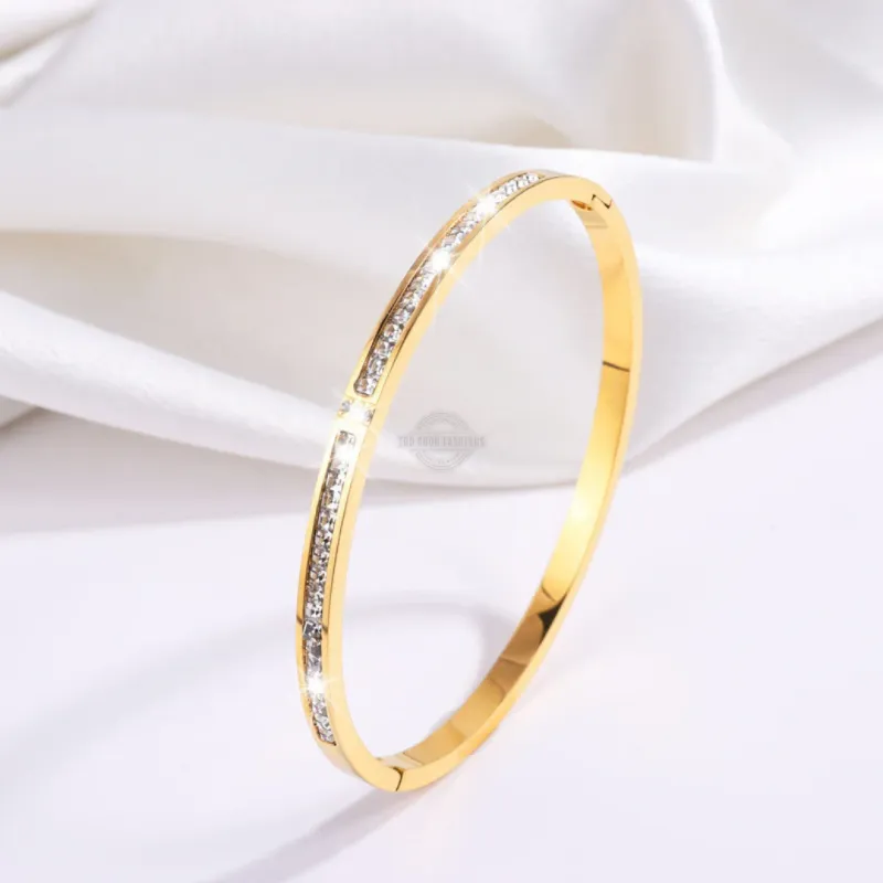 Gold stainless steel bangle with elegant inlaid gems
