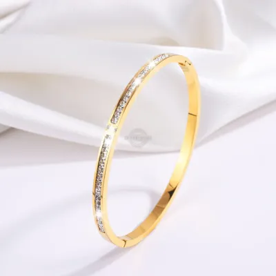 Gold stainless steel bangle with elegant inlaid gems