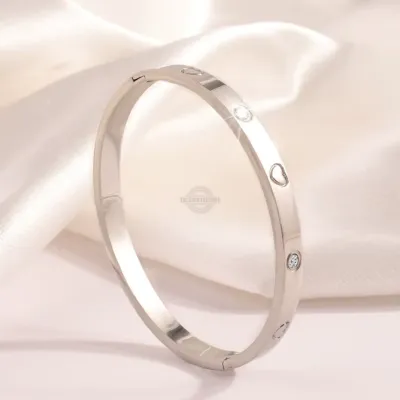 Silver stainless steel bangle with heart inlaid gems
