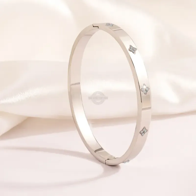 Silver stainless steel bangle with clover and inlaid gems