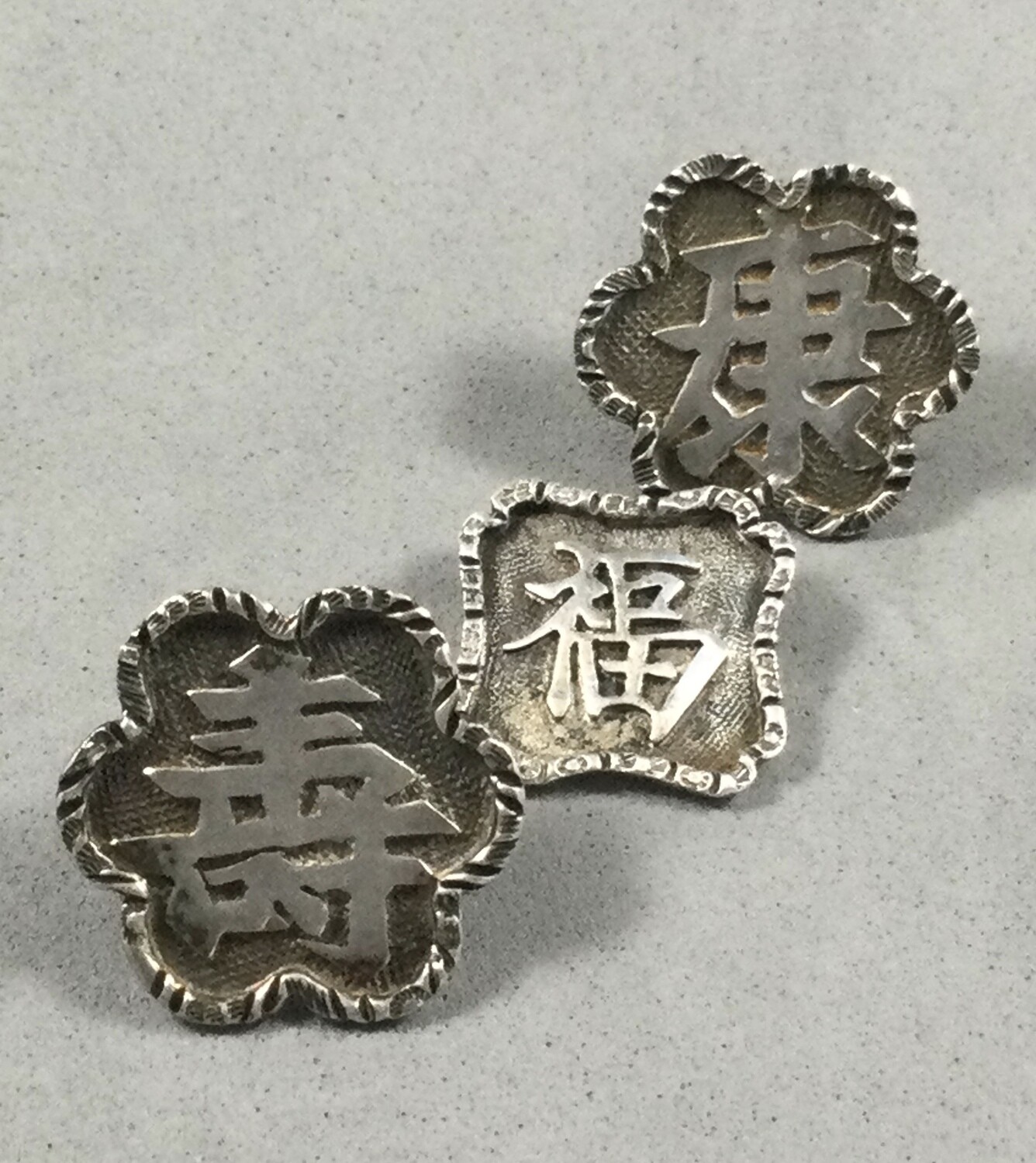 Three Medium Silver Shapes with Chinese Symbols