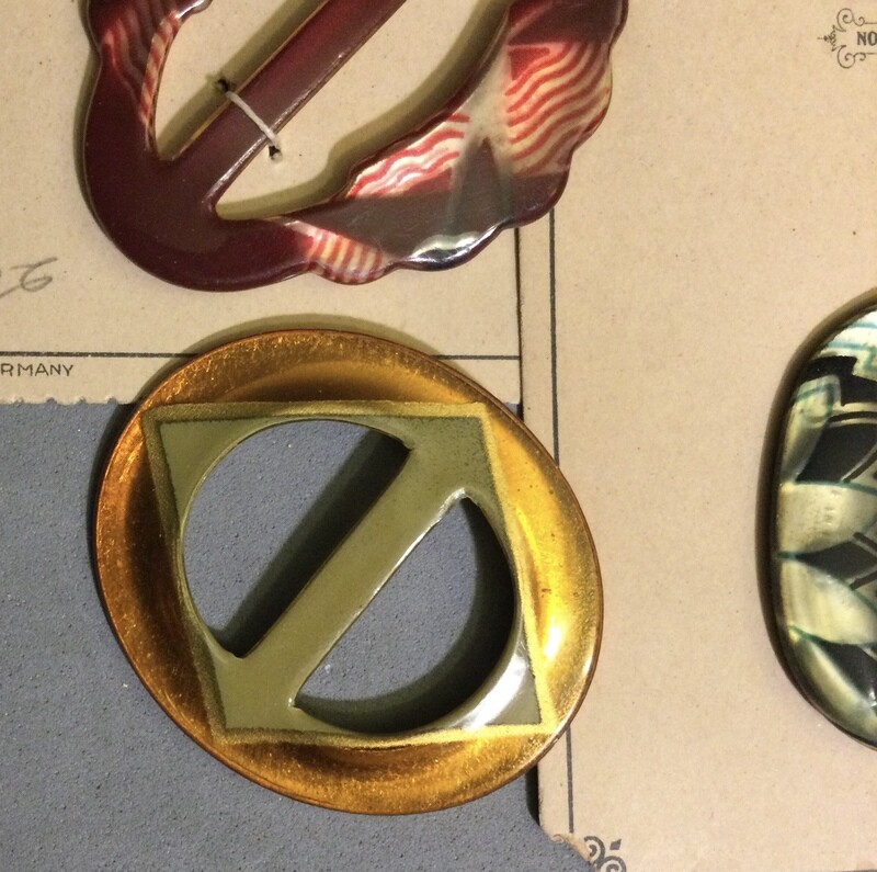 Four Celluloid Glow Buckles