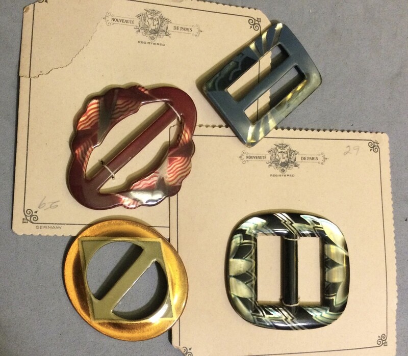 Four Celluloid Glow Buckles