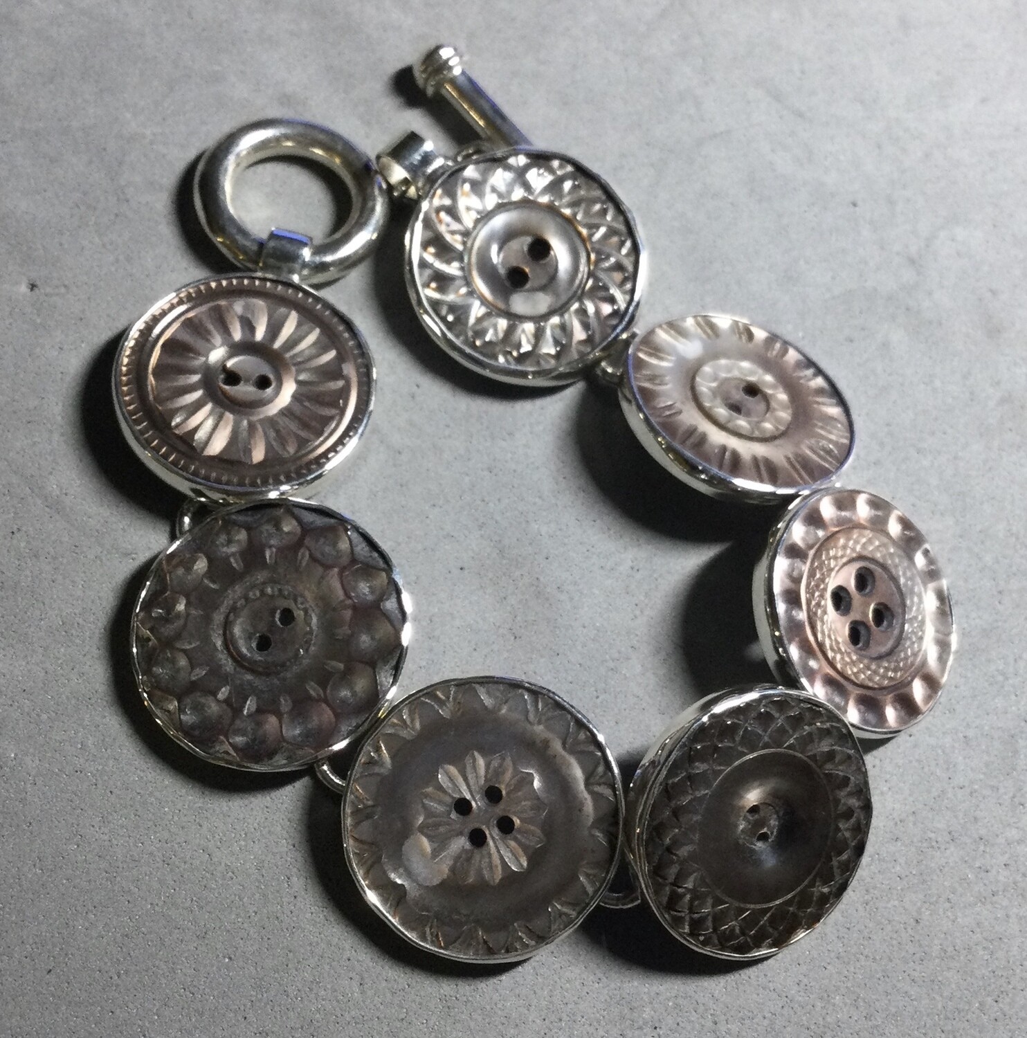 CARVED SMOKEY SHELL BUTTONS SET IN STERLING SILVER BRACELET