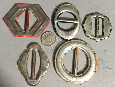 FIVE CELLULOID TIGHT TOP BUCKLES, including GLOWS