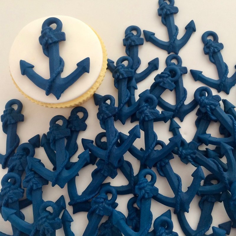 Royal blue anchors illustrated on a cupcake.